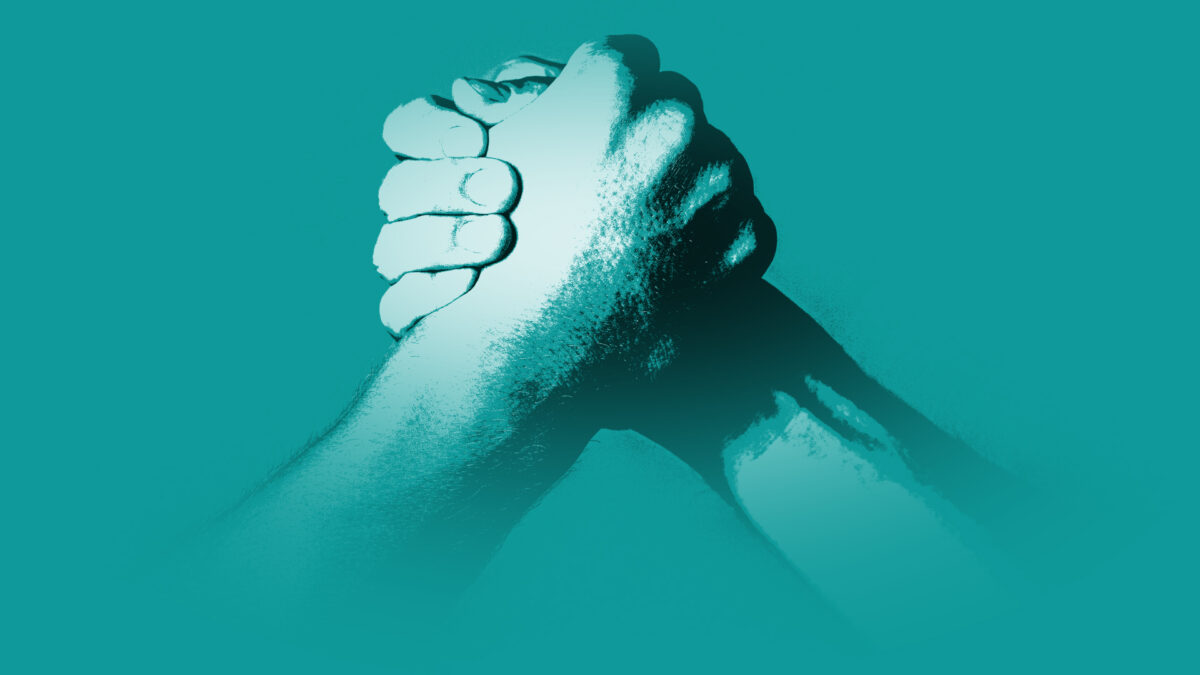 Two hands clasped in a gesture of solidarity