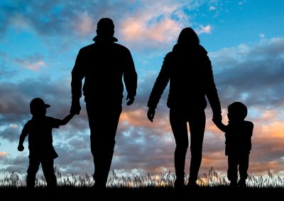 apr11-legislative-social The silhouette of a family walking outside at sunset