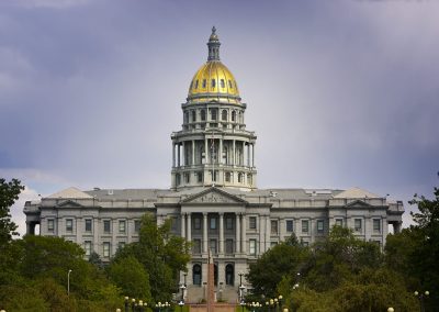 The Colorado Capitol is seen against dramatic skies