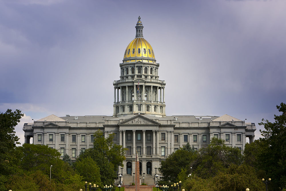 The Colorado Capitol is seen against dramatic skies